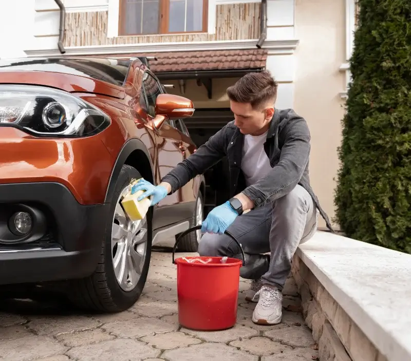 Lavage auto à domicile Grand'Combe-Châteleu : professionnel intervenant sur un véhicule